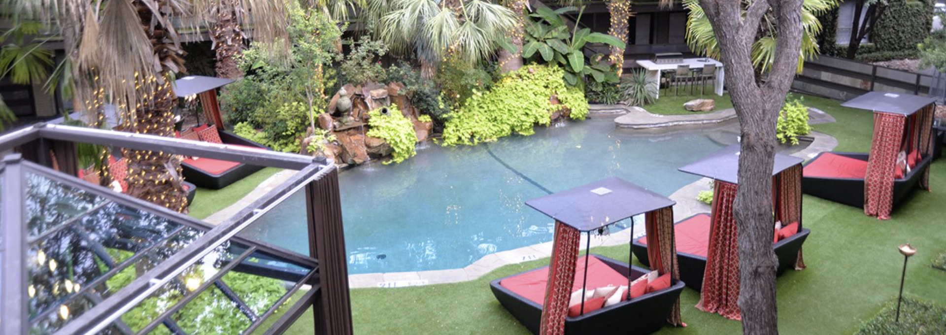a pool and lounge chairs in a backyard at The Verandah